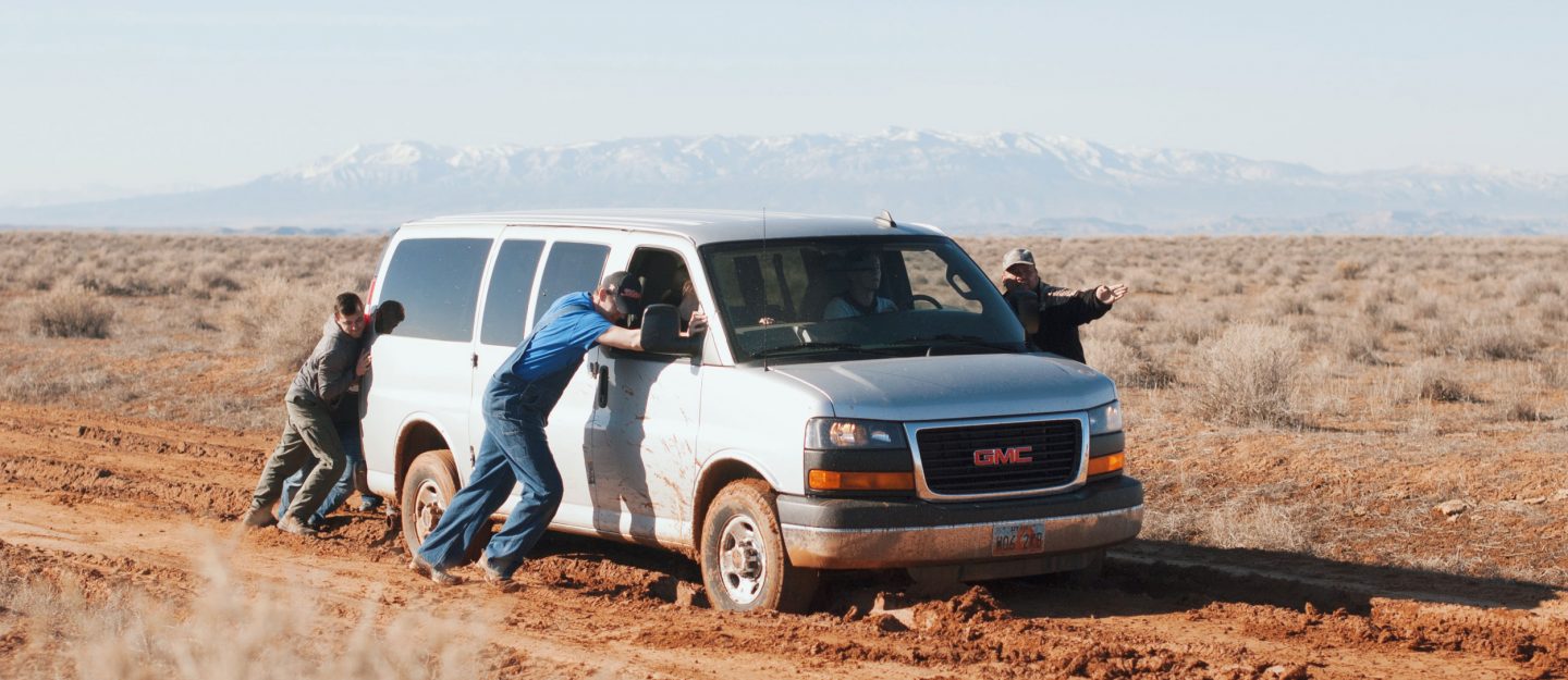 men pushing a car