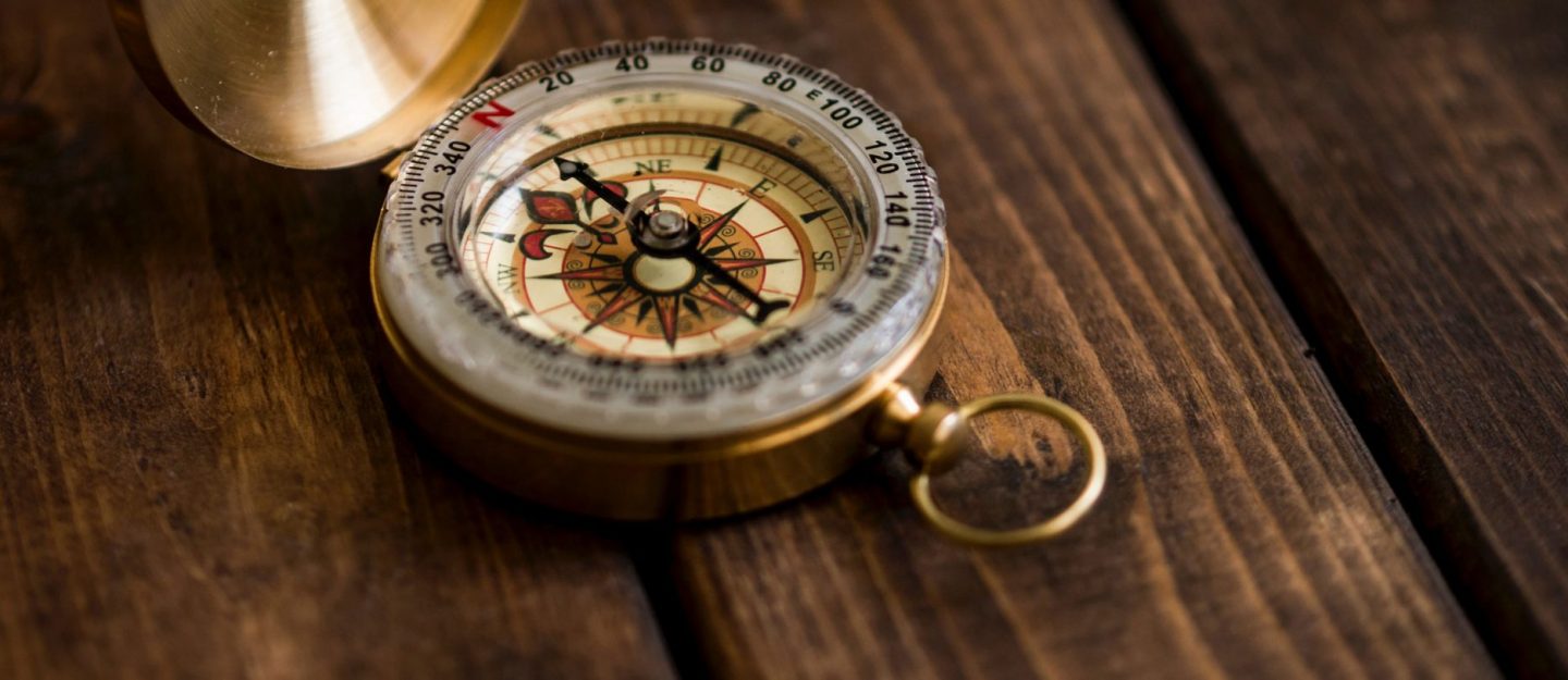 compass on a wooden table