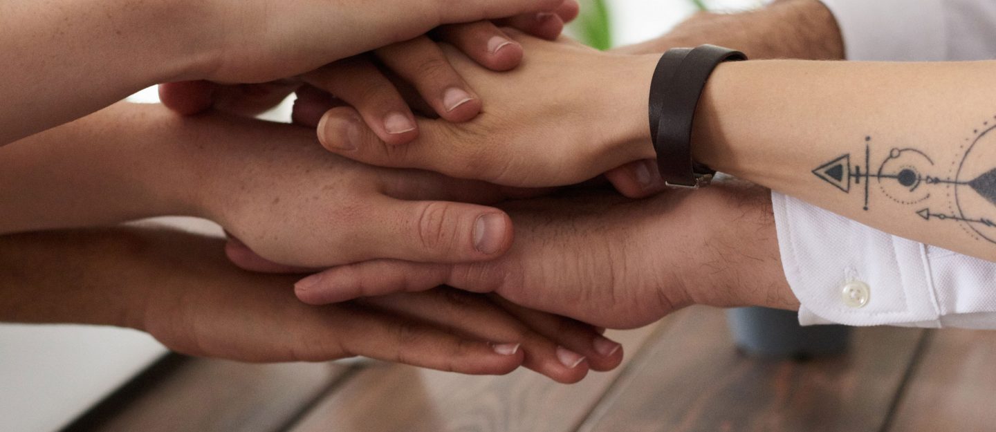 photo-of-hands-near-wooden-table