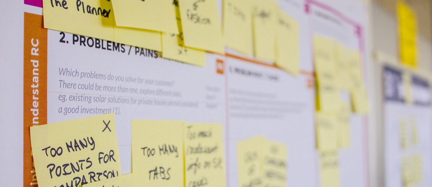 Scrum board with yellow postits showing tasks and problems.